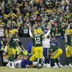 Green Bay Packers' Aaron Rodgers celebrates a touchdown run by Aaron Jones during the first half of an NFL divisional playoff football game against the Seattle Seahawks Sunday, Jan. 12, 2020, in Green Bay, Wis. (AP Photo/Mike Roemer)