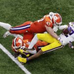 LSU wide receiver Justin Jefferson is tackled by Clemson linebacker James Skalski and safety Denzel Johnson during the second half of a NCAA College Football Playoff national championship game Monday, Jan. 13, 2020, in New Orleans. (AP Photo/Eric Gay)