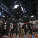 Phoenix Suns players pause during 24 seconds of silence in memory of Los Angeles Lakers' Kobe Bryant and others killed in a helicopter crash Sunday, prior to the Suns' NBA basketball game against the Oklahoma City Thunder on Friday, Jan. 31, 2020, in Phoenix. (AP Photo/Ross D. Franklin)