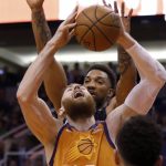Phoenix Suns' Aron Baynes (46) is fouled by Orlando Magic's Khem Birch, rear, during the second half of an NBA basketball game Friday, Jan. 10, 2020, in Phoenix. (AP Photo/Darryl Webb)