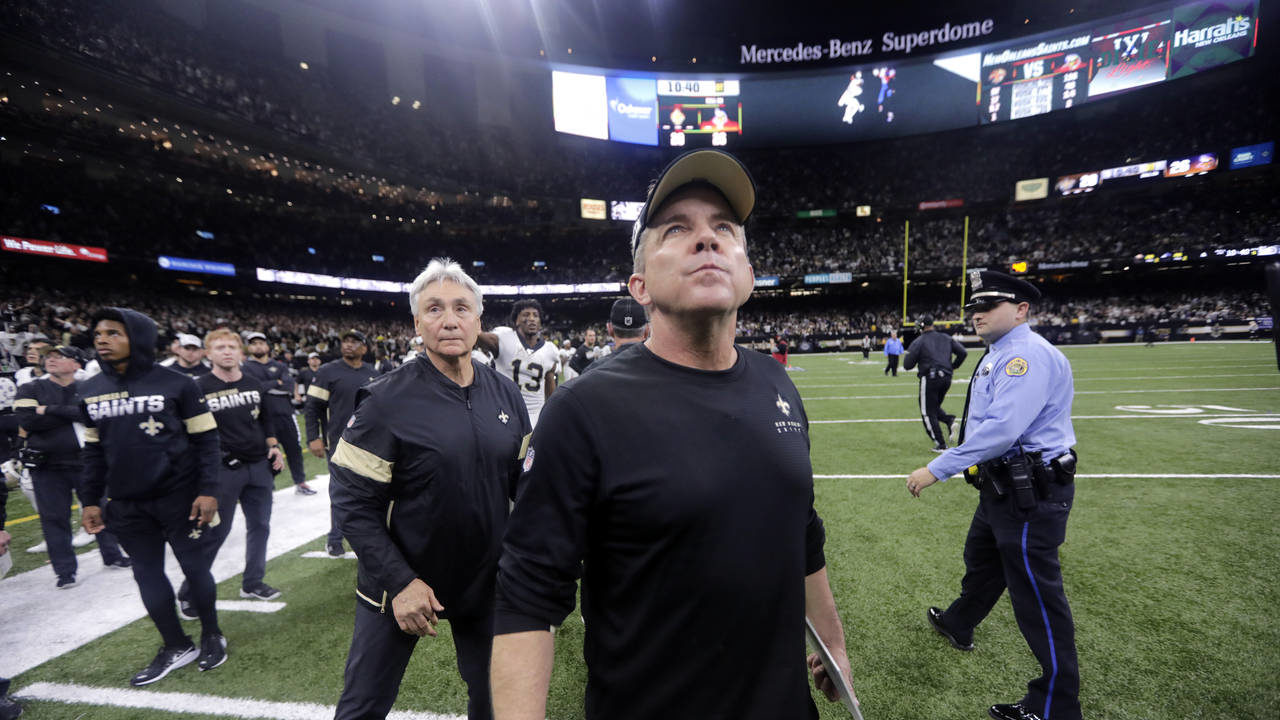 New Orleans Saints head coach Sean Payton looks up as he walks off the field after overtime of an N...