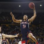 Arizona forward Ira Lee (11) goes in for a dunk as he gets past Arizona State forward Mickey Mitchell (00) during the first half of an NCAA college basketball game Saturday, Jan. 25, 2020, in Tempe, Ariz. (AP Photo/Ross D. Franklin)