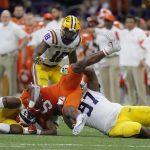 Clemson running back Travis Etienne is tackled by LSU defensive end Glen Logan during the first half of a NCAA College Football Playoff national championship game Monday, Jan. 13, 2020, in New Orleans. (AP Photo/Gerald Herbert)