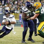 Seattle Seahawks' Russell Wilson runs for a first down during the second half of an NFL divisional playoff football game against the Green Bay Packers Sunday, Jan. 12, 2020, in Green Bay, Wis. (AP Photo/Matt Ludtke)
