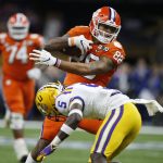 Clemson tight end Braden Galloway is tackled by LSU cornerback Kary Vincent Jr. during the first half of a NCAA College Football Playoff national championship game Monday, Jan. 13, 2020, in New Orleans. (AP Photo/Gerald Herbert)