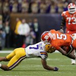 Clemson wide receiver Tee Higgins is tackled by LSU safety Grant Delpit during the second half of a NCAA College Football Playoff national championship game Monday, Jan. 13, 2020, in New Orleans. (AP Photo/David J. Phillip)