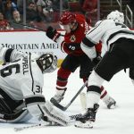 Arizona Coyotes center Christian Dvorak (18) scores a goal against Los Angeles Kings goaltender Jack Campbell, left, as Kings center Jeff Carter (77) arrives late to defend during the second period of an NHL hockey game Thursday, Jan. 30, 2020, in Glendale, Ariz. (AP Photo/Ross D. Franklin)