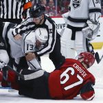 Linesman Bryan Pancich (94) pulls Los Angeles Kings left wing Kyle Clifford (13) off Arizona Coyotes left wing Lawson Crouse (67) during the second period of an NHL hockey game Thursday, Jan. 30, 2020, in Glendale, Ariz. The Kings won 3-2 in overtime. (AP Photo/Ross D. Franklin)