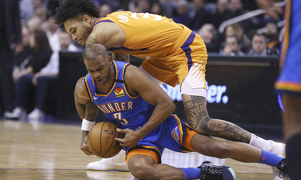 Oklahoma City Thunder guard Chris Paul (3) dives for a loose ball, beating Phoenix Suns forward Kel...