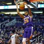 Phoenix Suns forward Mikal Bridges dunks over Charlotte Hornets guard Dwayne Bacon (7) during the second half of an NBA basketball game Sunday, Jan. 12, 2020, in Phoenix. Phoenix won 100-92. (AP Photo/Rick Scuteri)