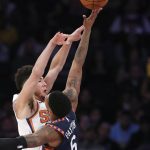 New York Knicks guard Elfrid Payton (6) blocks a pass by Phoenix Suns guard Devin Booker, left, during the first half of an NBA basketball game in New York, Thursday, Jan. 16, 2020. (AP Photo/Kathy Willens)