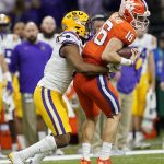 Clemson quarterback Trevor Lawrence is tackled by LSU safety JaCoby Stevens during the second half of a NCAA College Football Playoff national championship game Monday, Jan. 13, 2020, in New Orleans. (AP Photo/David J. Phillip)