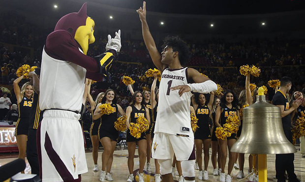 Arizona State guard Remy Martin (1) celebrates with mascot Sparky, cheerleaders and fans after an N...