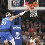 Dallas Mavericks center Willie Cauley-Stein (33) attempts a dunk as Phoenix Suns center Deandre Ayton (22) looks on during the first half of an NBA basketball game Tuesday, Jan. 28, 2020, in Dallas. (AP Photo/Ron Jenkins)