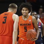 Oregon State's Tres Tinkle (3) congratulates Ethan Thompson (5) after Thompson forced a turnover, as Arizona's Max Hazzard walks behind, in the closing minute of an NCAA college basketball game in Corvallis, Ore., Sunday, Jan. 12, 2020. (AP Photo/Chris Pietsch)