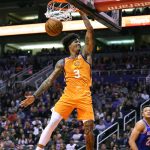 Phoenix Suns forward Kelly Oubre Jr. dunks next to New York Knicks forward Kevin Knox II during the second half of an NBA basketball game Friday, Jan. 3, 2020, in Phoenix. The Suns won 120-112. (AP Photo/Rick Scuteri)