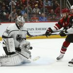 Los Angeles Kings goaltender Jack Campbell (36) makes a save as Arizona Coyotes center Derek Stepan, second from right, and Kings center Jeff Carter (77) battle for the puck during the second period of an NHL hockey game Thursday, Jan. 30, 2020, in Glendale, Ariz. (AP Photo/Ross D. Franklin)