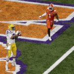 LSU tight end Thaddeus Moss scores as Clemson cornerback Derion Kendrick looks on during the first half of a NCAA College Football Playoff national championship game Monday, Jan. 13, 2020, in New Orleans. (AP Photo/Eric Gay)