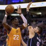 Phoenix Suns' Deandre Ayton (22) looks to the basket as Orlando Magic's Nikola Vucevic (9) defends during the second half of an NBA basketball game Friday, Jan. 10, 2020, in Phoenix. (AP Photo/Darryl Webb)