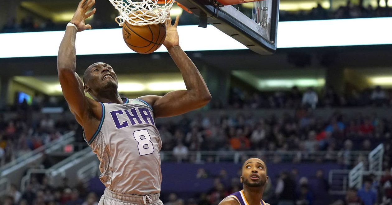 Charlotte Hornets center Bismack Biyombo dunks over Phoenix Suns forward Mikal Bridges (25) during ...