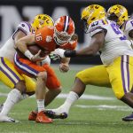 Clemson quarterback Trevor Lawrence gets sacked by LSU during the second half of a NCAA College Football Playoff national championship game Monday, Jan. 13, 2020, in New Orleans. (AP Photo/Gerald Herbert)