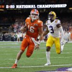 Clemson quarterback Trevor Lawrence scores past LSU safety JaCoby Stevens during the first half of a NCAA College Football Playoff national championship game Monday, Jan. 13, 2020, in New Orleans. (AP Photo/Gerald Herbert)