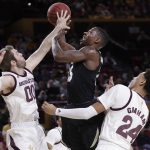 Colorado guard McKinley Wright IV, center, has his shot blocked by Arizona State Mickey Mitchell (00) as Arizona State forward Andre Allen (24) looks on during the first half of an NCAA college basketball game, Thursday, Jan. 16, 2020, in Tempe, Ariz. (AP Photo/Matt York)