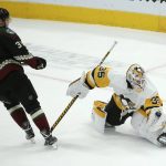 Pittsburgh Penguins goaltender Tristan Jarry (35) makes a save on a shot by Arizona Coyotes center Carl Soderberg (34) during the shootout of an NHL hockey game Sunday, Jan. 12, 2020, in Glendale, Ariz. The Penguins defeated the Coyotes 4-3. (AP Photo/Ross D. Franklin)
