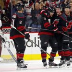 Carolina Hurricanes' Warren Foegele (13) is congratulated on his goal by teammates Andrei Svechnikov (37), of Russia, and Jake Gardiner (51) during the first period of an NHL hockey game against the Arizona Coyotes in Raleigh, N.C., Friday, Jan. 10, 2020. (AP Photo/Karl B DeBlaker)