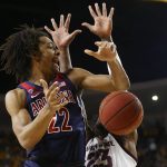 Arizona forward Zeke Nnaji (22) is fouled by Arizona State forward Romello White (23) as he goes up to shoot during the first half of an NCAA college basketball game Saturday, Jan. 25, 2020, in Tempe, Ariz. (AP Photo/Ross D. Franklin)