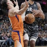 San Antonio Spurs' LaMarcus Aldridge (12) collides with Phoenix Suns' Dario Saric during the first half of an NBA basketball game, Friday, Jan. 24, 2020, in San Antonio. (AP Photo/Darren Abate)