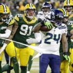 Green Bay Packers' Jaire Alexander (23) and others try to stop Seattle Seahawks' Marshawn Lynch (24) during the first half of an NFL divisional playoff football game Sunday, Jan. 12, 2020, in Green Bay, Wis. (AP Photo/Mike Roemer)