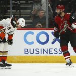 Arizona Coyotes center Brad Richardson (15) smiles after scoring a goal as Anaheim Ducks center Ryan Getzlaf (15) pauses on the ice during the third period of an NHL hockey game Thursday, Jan. 2, 2020, in Glendale, Ariz. The Coyotes won 4-2. (AP Photo/Ross D. Franklin)