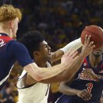Arizona State guard Remy Martin, middle, tries to control the ball as he drives between Arizona guard Nico Mannion (1) and Arizona guard Dylan Smith (3) during the second half of an NCAA college basketball game Saturday, Jan. 25, 2020, in Tempe, Ariz. Arizona State defeated Arizona 66-65. (AP Photo/Ross D. Franklin)