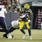 Green Bay Packers' Aaron Jones runs during the first half of an NFL divisional playoff football game against the Seattle Seahawks Sunday, Jan. 12, 2020, in Green Bay, Wis. (AP Photo/Mike Roemer)