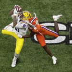 LSU tight end Thaddeus Moss catches a pass over Clemson cornerback Derion Kendrick during the first half of a NCAA College Football Playoff national championship game Monday, Jan. 13, 2020, in New Orleans. (AP Photo/Eric Gay)