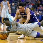 Charlotte Hornets guard Dwayne Bacon (7) and Phoenix Suns guard Devin Booker (1) dive for the loose ball during the second half of an NBA basketball game Sunday, Jan. 12, 2020, in Phoenix. Phoenix won 100-92. (AP Photo/Rick Scuteri)
