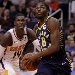 Indiana Pacers forward Justin Holiday (8) drives past Phoenix Suns forward Cheick Diallo (14) during the first half of an NBA basketball game, Wednesday, Jan. 22, 2020, in Phoenix. (AP Photo/Matt York)