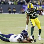 Green Bay Packers' Aaron Jones runs past Seattle Seahawks' Bryan Mone during the first half of an NFL divisional playoff football game Sunday, Jan. 12, 2020, in Green Bay, Wis. (AP Photo/Darron Cummings)