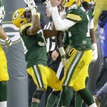 Green Bay Packers' Aaron Rodgers celebrates with Aaron Jones (33) after a touchdown run during the first half of an NFL divisional playoff football game against the Seattle Seahawks Sunday, Jan. 12, 2020, in Green Bay, Wis. (AP Photo/Mike Roemer)