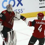 Arizona Coyotes goaltender Adin Hill (31) celebrates a win against the San Jose Sharks with Coyotes defenseman Niklas Hjalmarsson (4) as time expires in the third period of an NHL hockey game Tuesday, Jan. 14, 2020, in Glendale, Ariz. The Coyotes defeated the Sharks 6-3. (AP Photo/Ross D. Franklin)