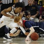 Arizona State guard Remy Martin, left, battles with Arizona guard Nico Mannion, right, for a loose ball during the second half of an NCAA college basketball game Saturday, Jan. 25, 2020, in Tempe, Ariz. Arizona State defeated Arizona 66-65. (AP Photo/Ross D. Franklin)