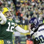 Green Bay Packers' Aaron Rodgers passes while being rushed by Seattle Seahawks' Jarran Reed during the first half of an NFL divisional playoff football game Sunday, Jan. 12, 2020, in Green Bay, Wis. (AP Photo/Darron Cummings)