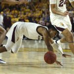Arizona State guard Remy Martin, middle, gets tripped up by Arizona forward Zeke Nnaji, left, as Martin collides with Arizona State forward Jalen Graham (24) during the second half of an NCAA college basketball game Saturday, Jan. 25, 2020, in Tempe, Ariz. Arizona State defeated Arizona 66-65. (AP Photo/Ross D. Franklin)
