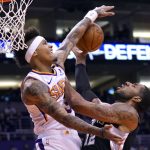 Phoenix Suns forward Kelly Oubre Jr. (3) blocks the shot on San Antonio Spurs center LaMarcus Aldridge during the first half of an NBA basketball game Monday, Jan. 20, 2020, in Phoenix. (AP Photo/Rick Scuteri)