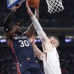 Phoenix Suns center Aron Baynes (46) defends as New York Knicks forward Julius Randle (30) goes up for a shot during the first quarter of an NBA basketball game in New York, Thursday, Jan. 16, 2020. (AP Photo/Kathy Willens)