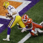 LSU quarterback Joe Burrow scores past Clemson safety Denzel Johnson during the first half of a NCAA College Football Playoff national championship game Monday, Jan. 13, 2020, in New Orleans. (AP Photo/Eric Gay)