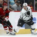 Arizona Coyotes right wing Clayton Keller (9) and Los Angeles Kings defenseman Matt Roy (3) go after a puck in the air during the first period of an NHL hockey game Thursday, Jan. 30, 2020, in Glendale, Ariz. (AP Photo/Ross D. Franklin)