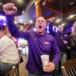 Peter Ochinko cheers on LSU while watching them against Clemson in the NCAA College Football Playoff championship game at Walk-On's Sports Bistreaux, in Baton Rouge, La., Monday, Jan. 13, 2020. (AP Photo/Brett Duke)