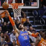 Oklahoma City Thunder center Steven Adams (12) gets off a shot next to Phoenix Suns center Deandre Ayton, right, during the second half of an NBA basketball game Friday, Jan. 31, 2020, in Phoenix. The Thunder defeated the Suns 111-107. (AP Photo/Ross D. Franklin)